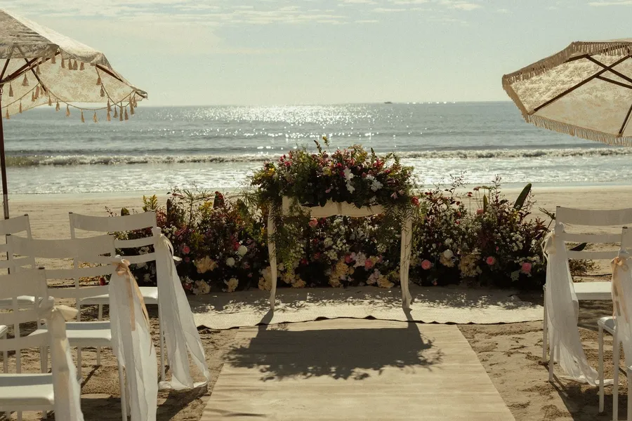 A beach wedding ceremony set up facing the ocean
