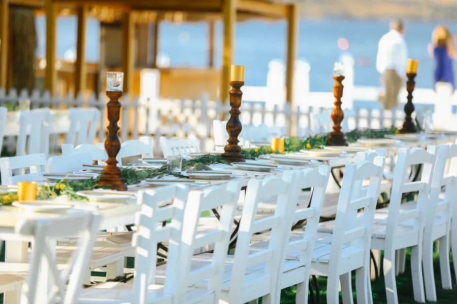 An outdoor wedding reception table setting by the sea