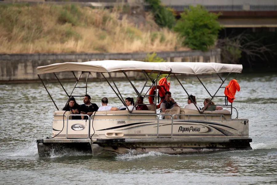 Friends riding a pontoon boat on the water