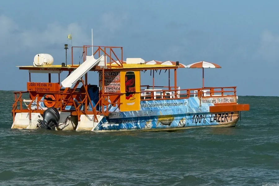 A double-decker boat with a water slide