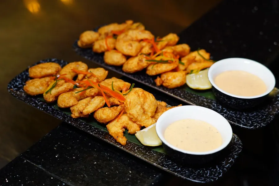 Crispy fried shrimp platters with dipping sauces