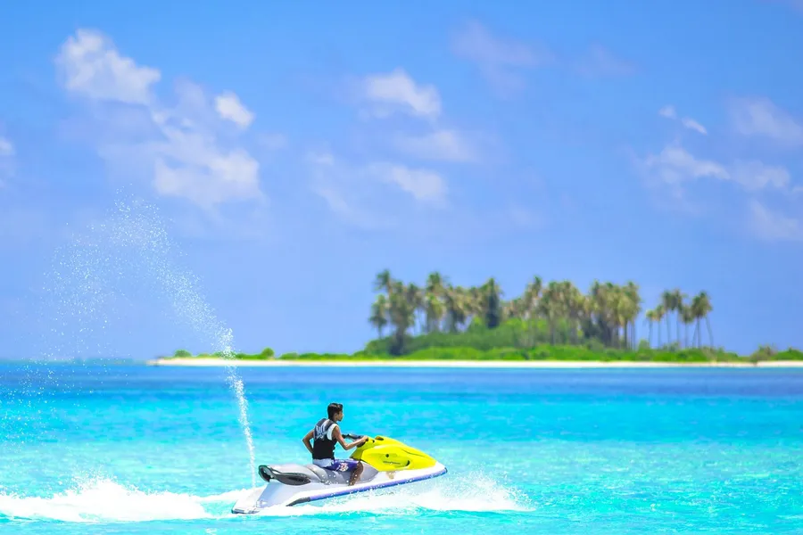 Riding a jet ski through bright blue water