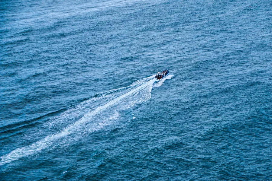 A jet ski cutting across the open ocean, seen from above